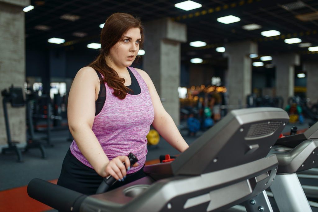 Overweight Woman Running on Treadmill