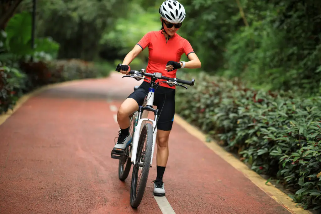 Woman Cyclist Looking at Sports Watch