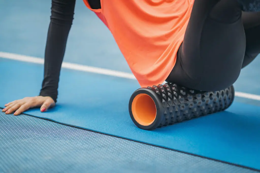 Female Athlete using Foam Roller