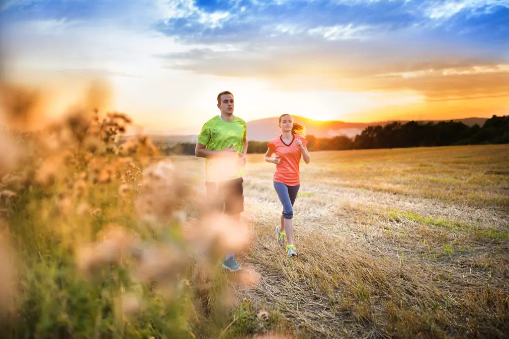 Couple running at sunset