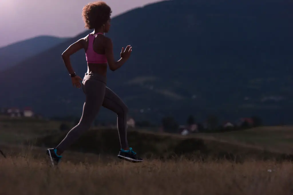 Young African Woman Jogging in Nature