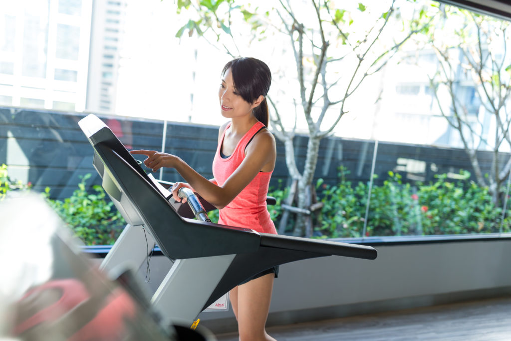 Woman Running On An Outdoor Treadmill